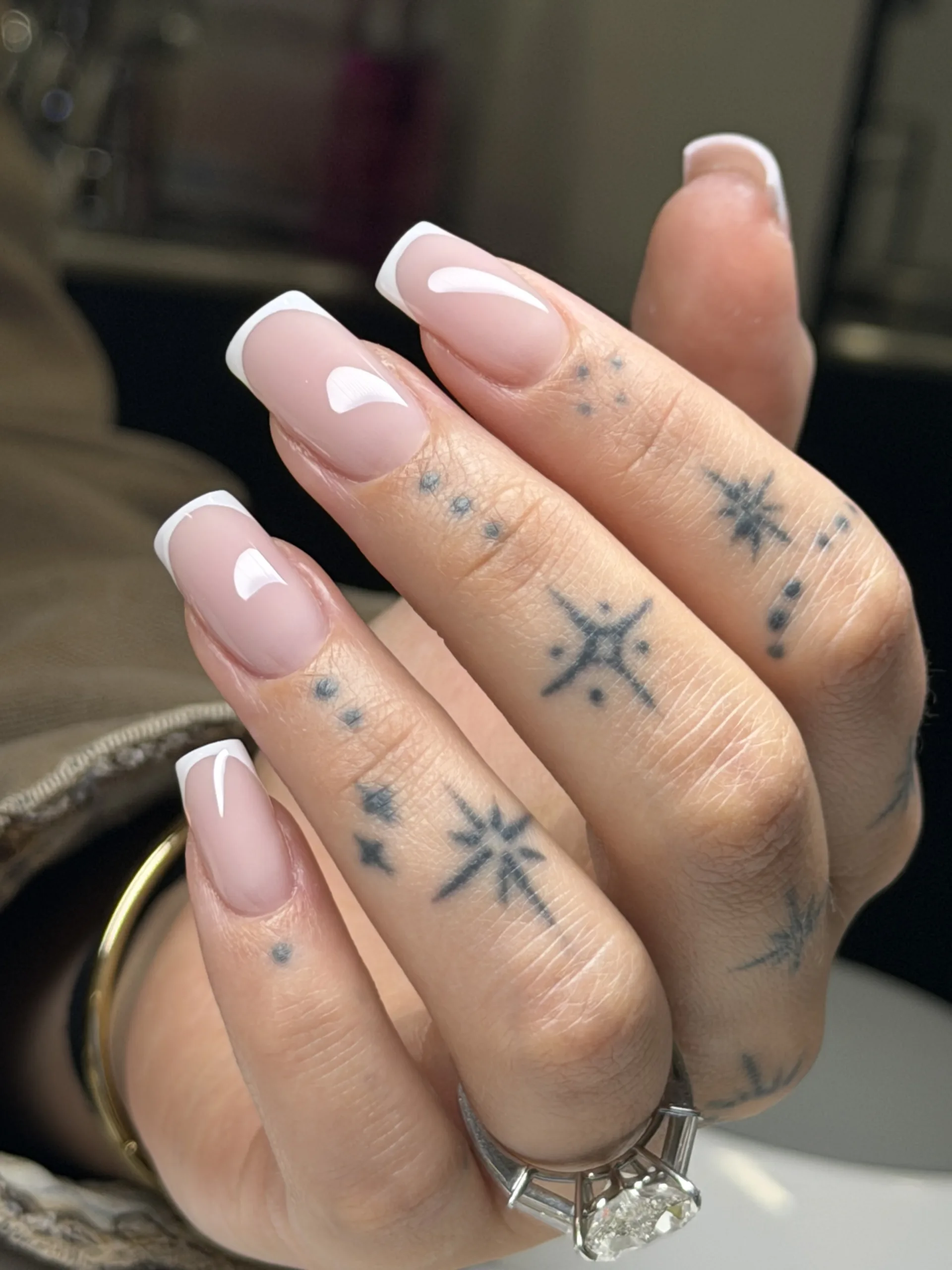 Classic white French manicure with delicate white accent nail art on square nails