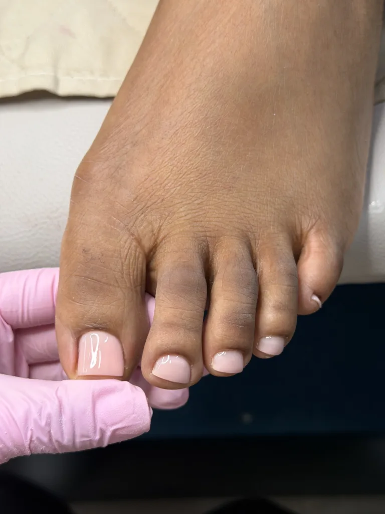 Soft pink pedicure with short, neatly shaped toenails