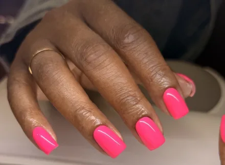 Bright pink manicure on a hand